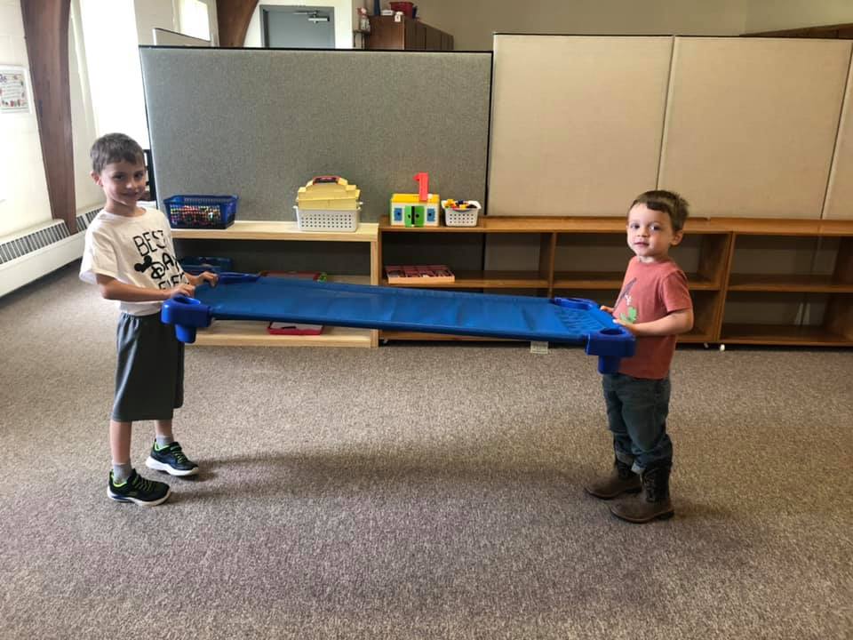 boys helping out in classroom at a Preschool & Daycare Serving Brighton, MI