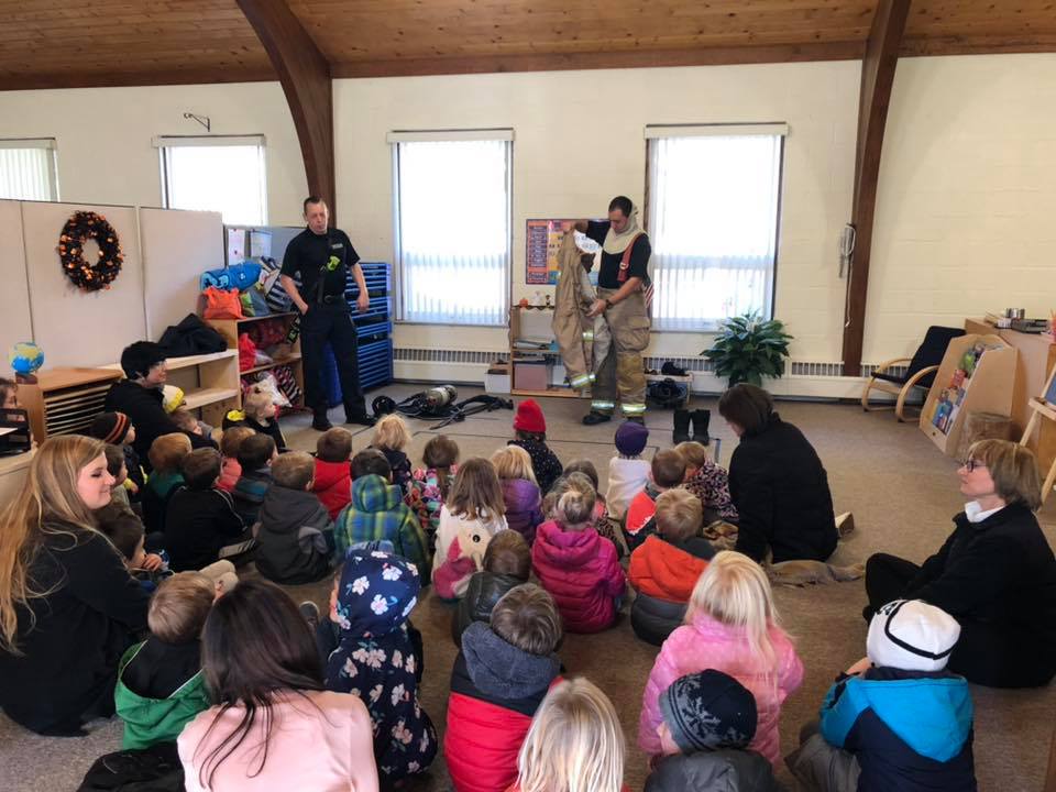 kids in classroom learning from firemen at a Preschool & Daycare Serving Brighton, MI