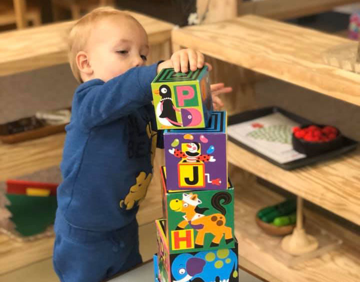 toddler playing with wood blocks at a Preschool & Daycare Serving Brighton, MI