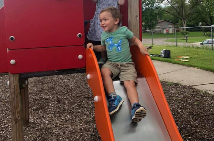 young boy having fun in playground at a Preschool & Daycare Serving Brighton, MI